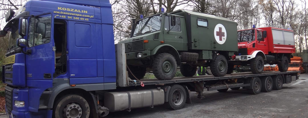 U1300L Unimogs loaded on flatbed in Europe